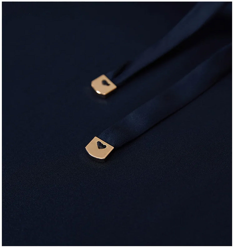 Macro shot of the silk drawstring ends finished with gold-tone metal tips. — From Borcelleclothes.