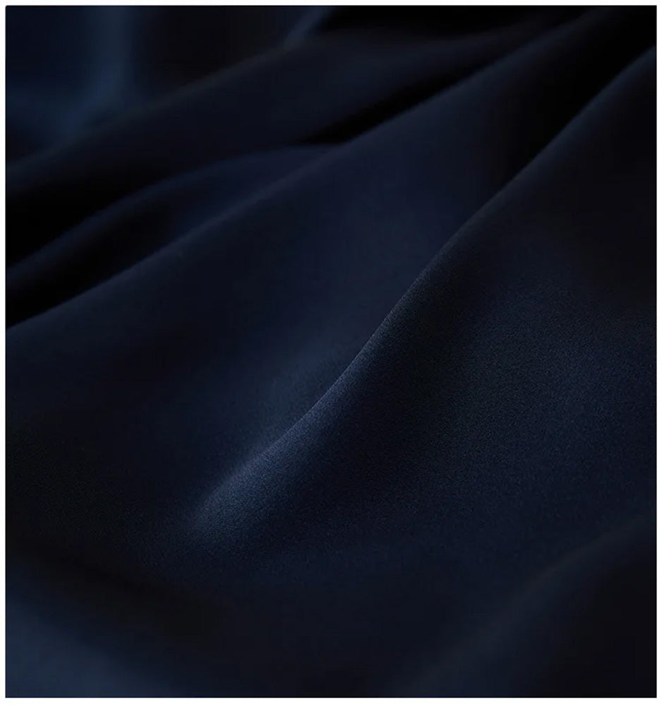 Close-up of the double georgette silk in Monticola Solitarius, showing the rich, wave-like folded texture of the matte fabric. — From Borcelleclothes.