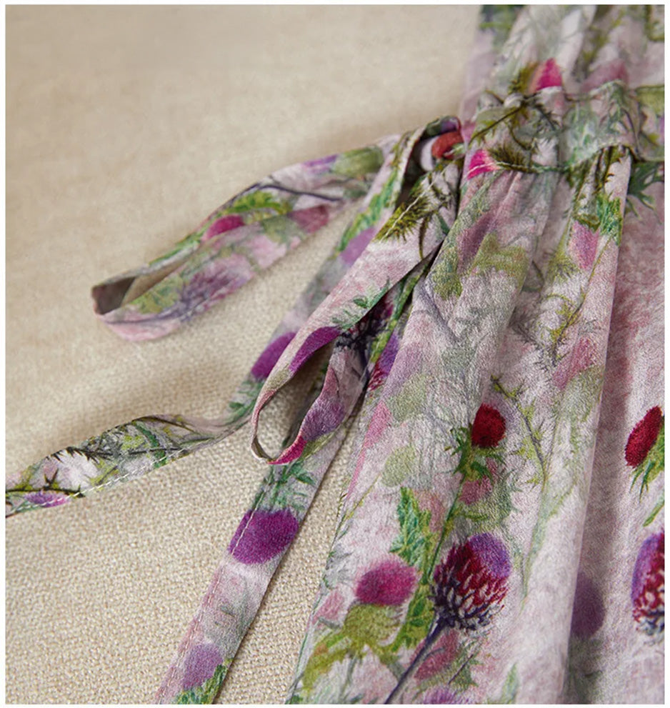The long silk sash tied into a soft bow at the side, anchoring the draped pleats and defining the woman’s waist with grace. — From Borcelleclothes.