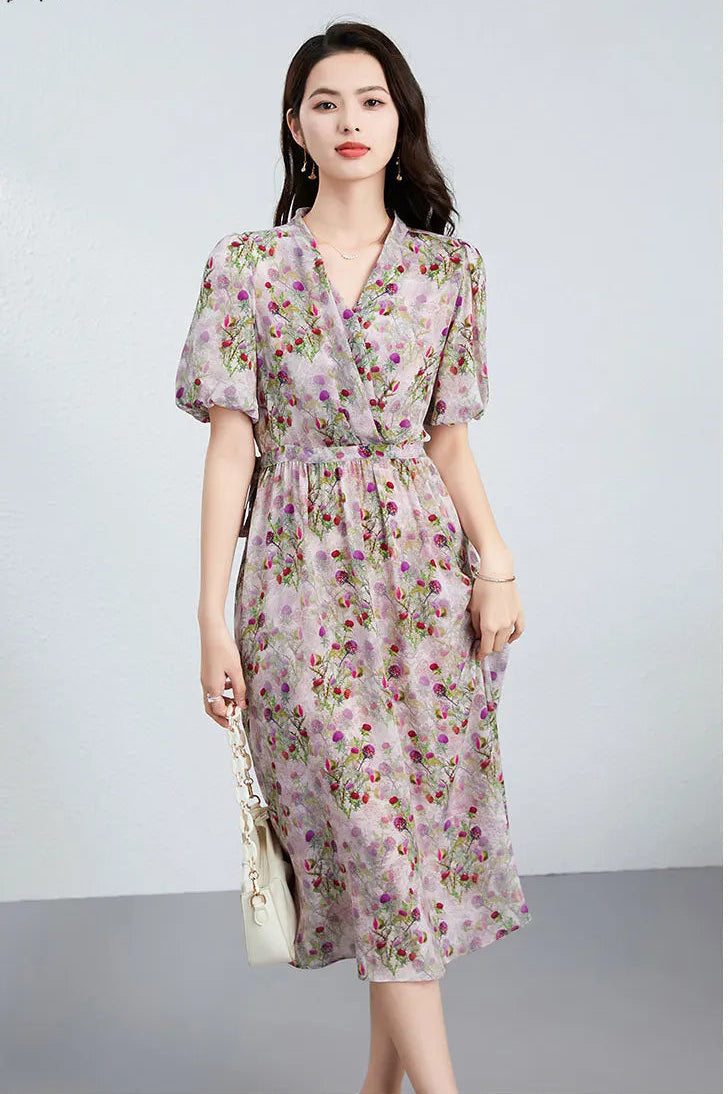 The elegant silhouette of the Thistle Grace dress on a woman; the draping pleats at the waist create a sculptural yet intimate volume in motion. — From Borcelleclothes.