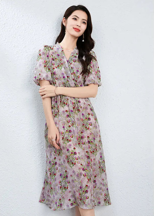A woman gently resting her hand on her forearm, feeling the matte texture of the silk crepe de chine; a gesture of quiet confidence that highlights the intimate draping of the Thistle Grace dress. — From Borcelleclothes.
