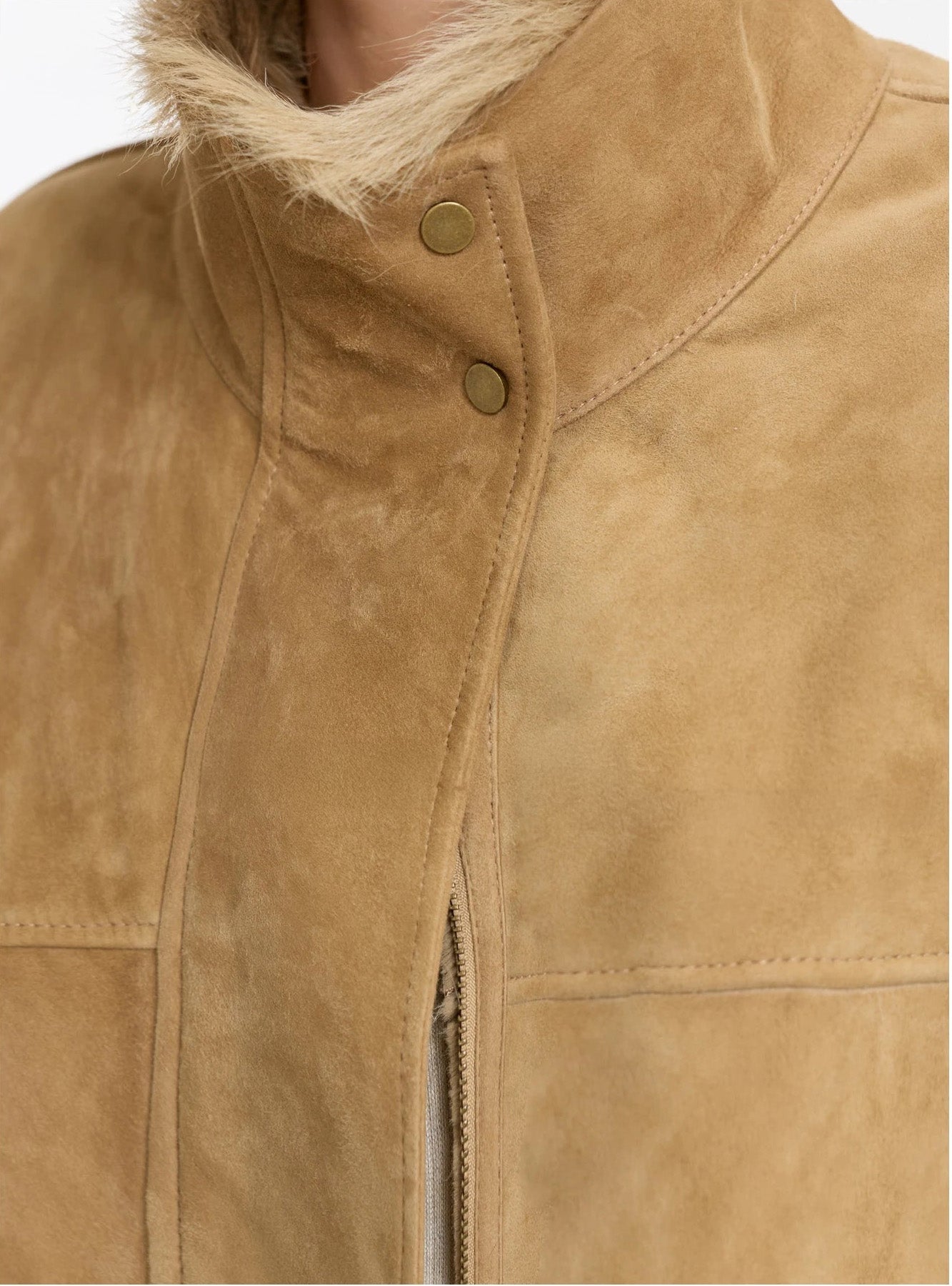 Close-up of a stand collar fastened on a Goatskin jacket in Late Wheat — From Borcelleclothes.
