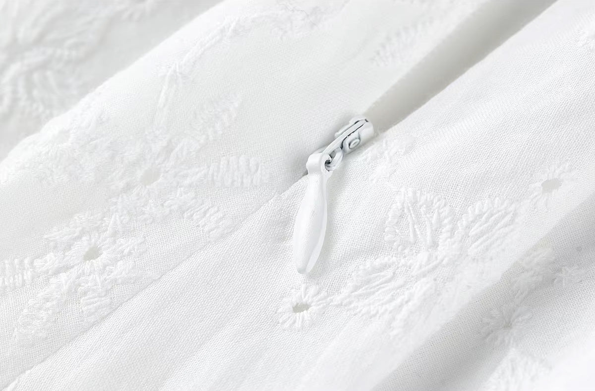 Technical close-up view of the discrete unzipped invisible zipper on the right side seam of the cotton skirt — From Borcelleclothes.