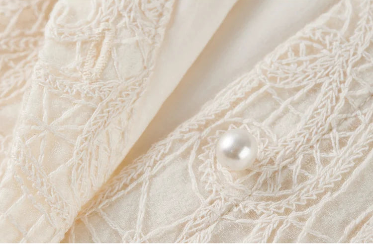 One pearl button unfastened, a subtle detail revealing the "broken boundary" and the lightness of the design. — From Borcelleclothes.