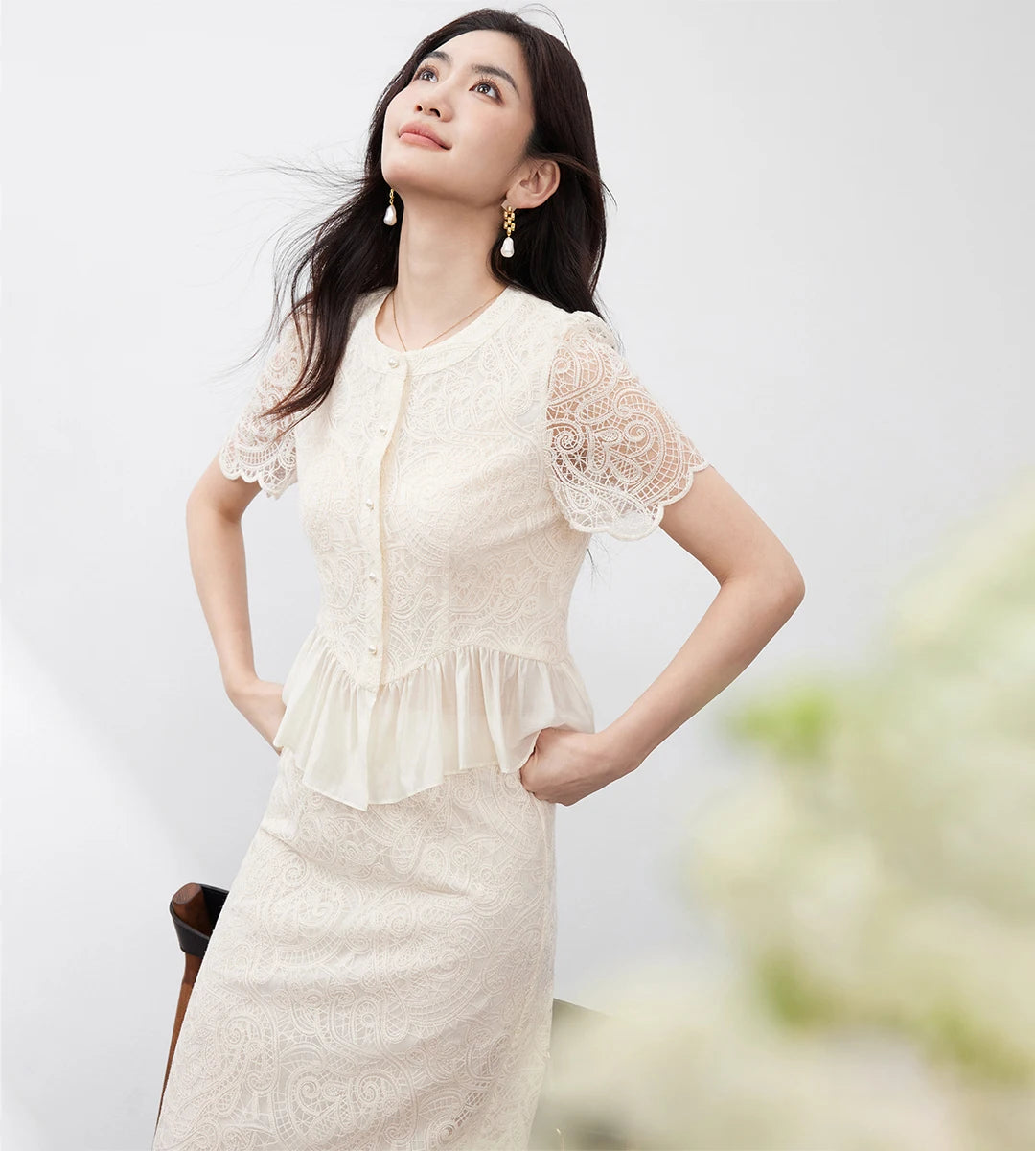 A moment of grace and poise, capturing the sophisticated round neckline and the scalloped sleeve details. — From Borcelleclothes.