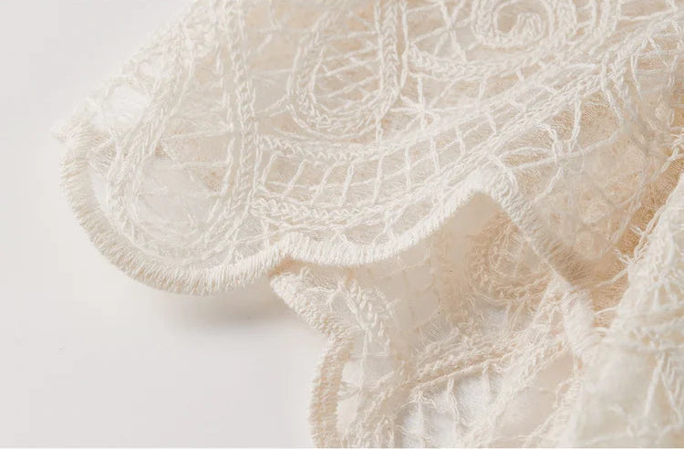 The scalloped hemline of the pencil skirt, echoing the artisanal craftsmanship of traditional lace. — From Borcelleclothes.