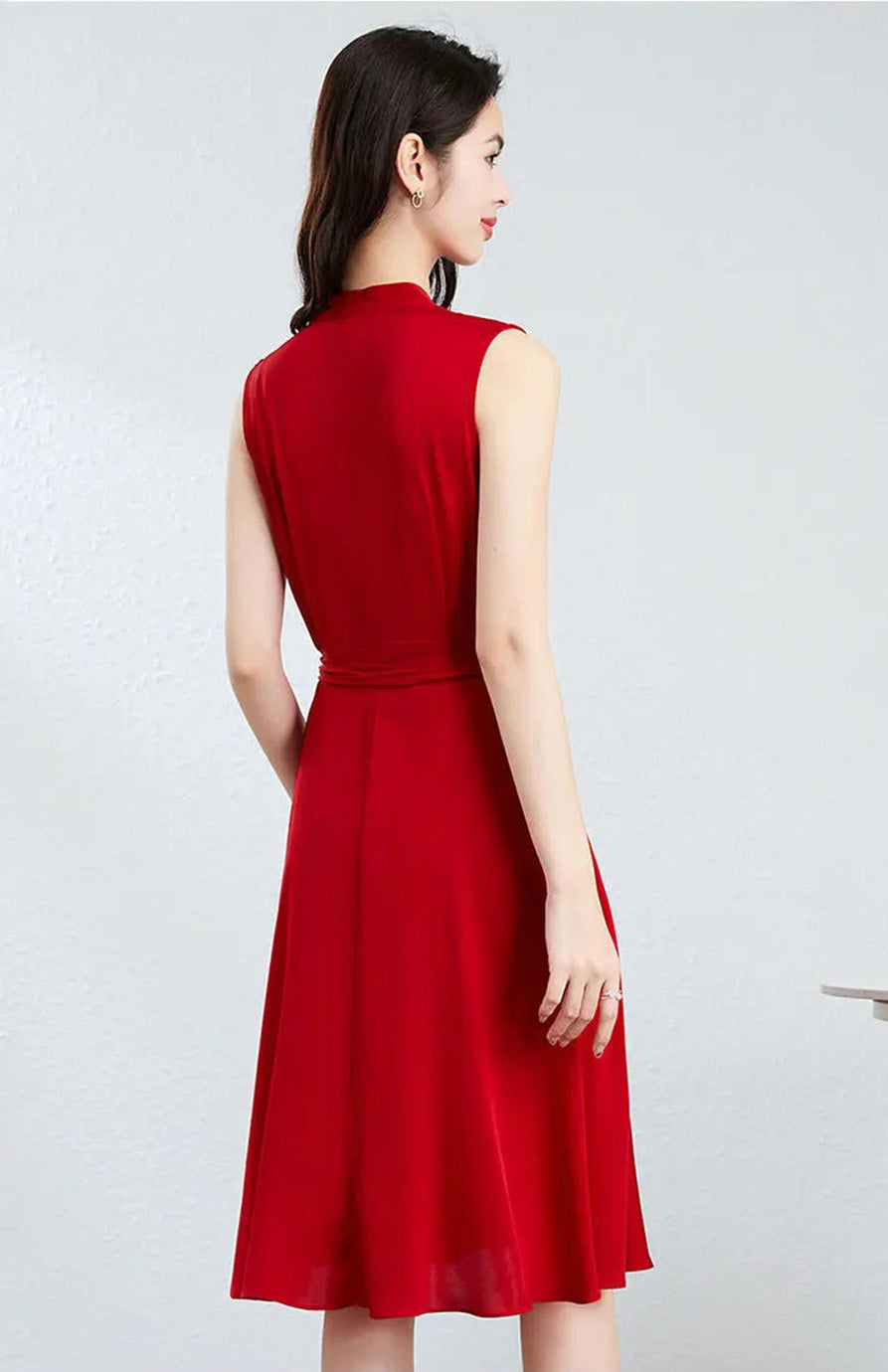 Rear view of a woman in a red midi dress, emphasizing the two deep waist darts and the seamed waistline — From Borcelleclothes.