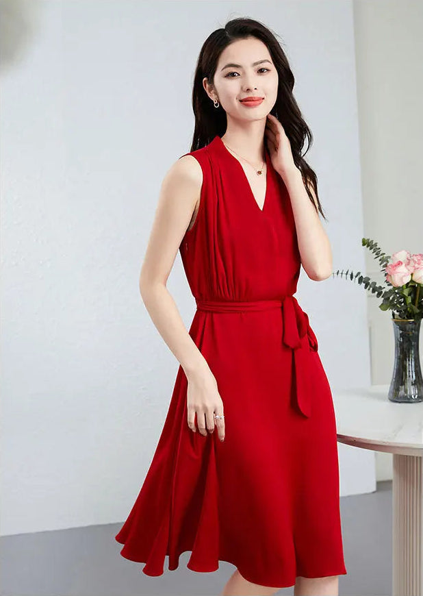The fluid movement of the 19-momme silk double georgette is captured as the model walks, showing the dress's side profile — From Borcelleclothes.