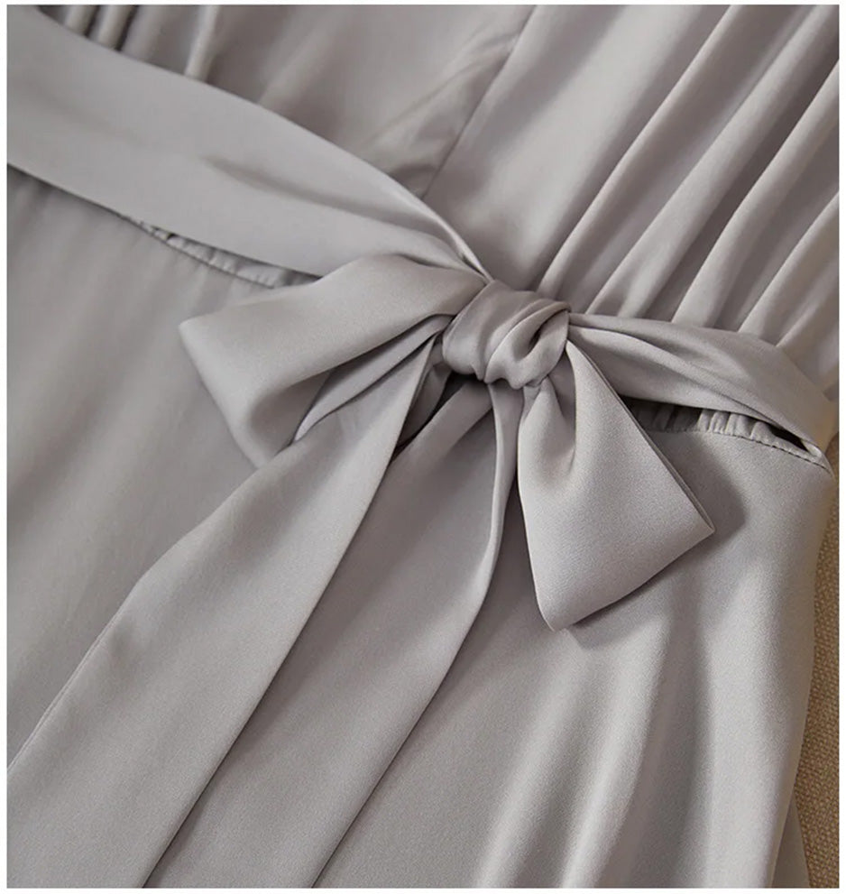 Close-up of the matching silk self-tie belt fastened in a bow at the seamed waist — From Borcelleclothes.