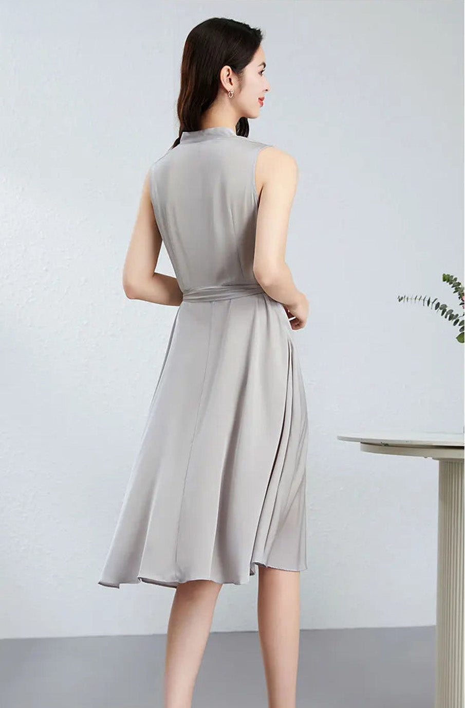 The back of the Taste of Win dress on a woman, displaying the precise tailoring and invisible side zipper placement — From Borcelleclothes.
