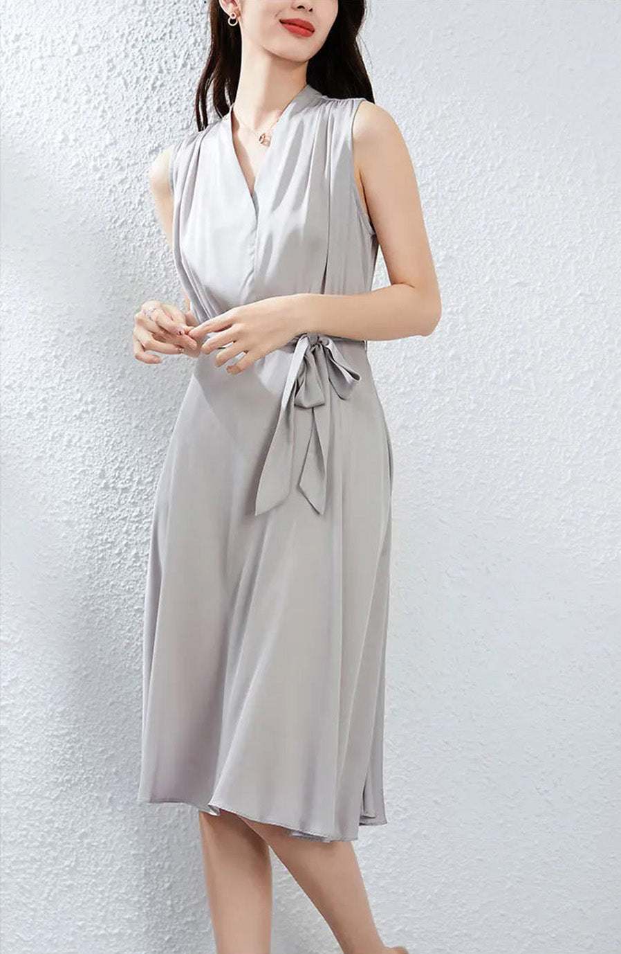 A delicate pose highlighting the soft texture of the Mulberry silk and the dress's refined seamed waist — From Borcelleclothes.