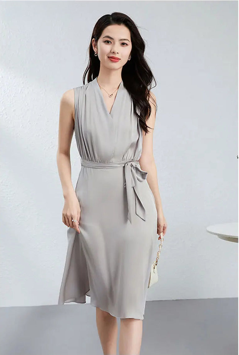 The model walks toward the camera in a midi-length silk dress, showing the dynamic drape of the Mulberry silk — From Borcelleclothes.