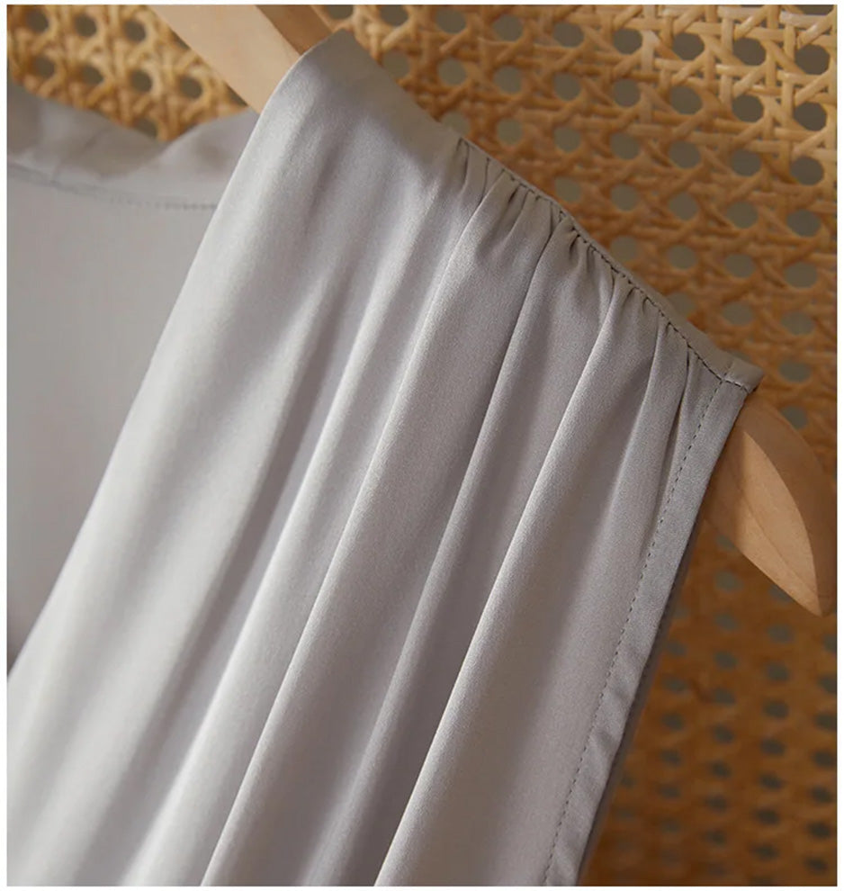 Detail of the sculptural peripheral draping at the shoulder, showcasing the architectural approach to silk — From Borcelleclothes.