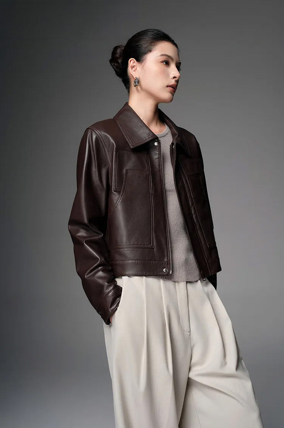 Model in the Rich Juniper cropped sheepskin jacket, hands in trouser pockets and looking to the side — From Borcelleclothes.