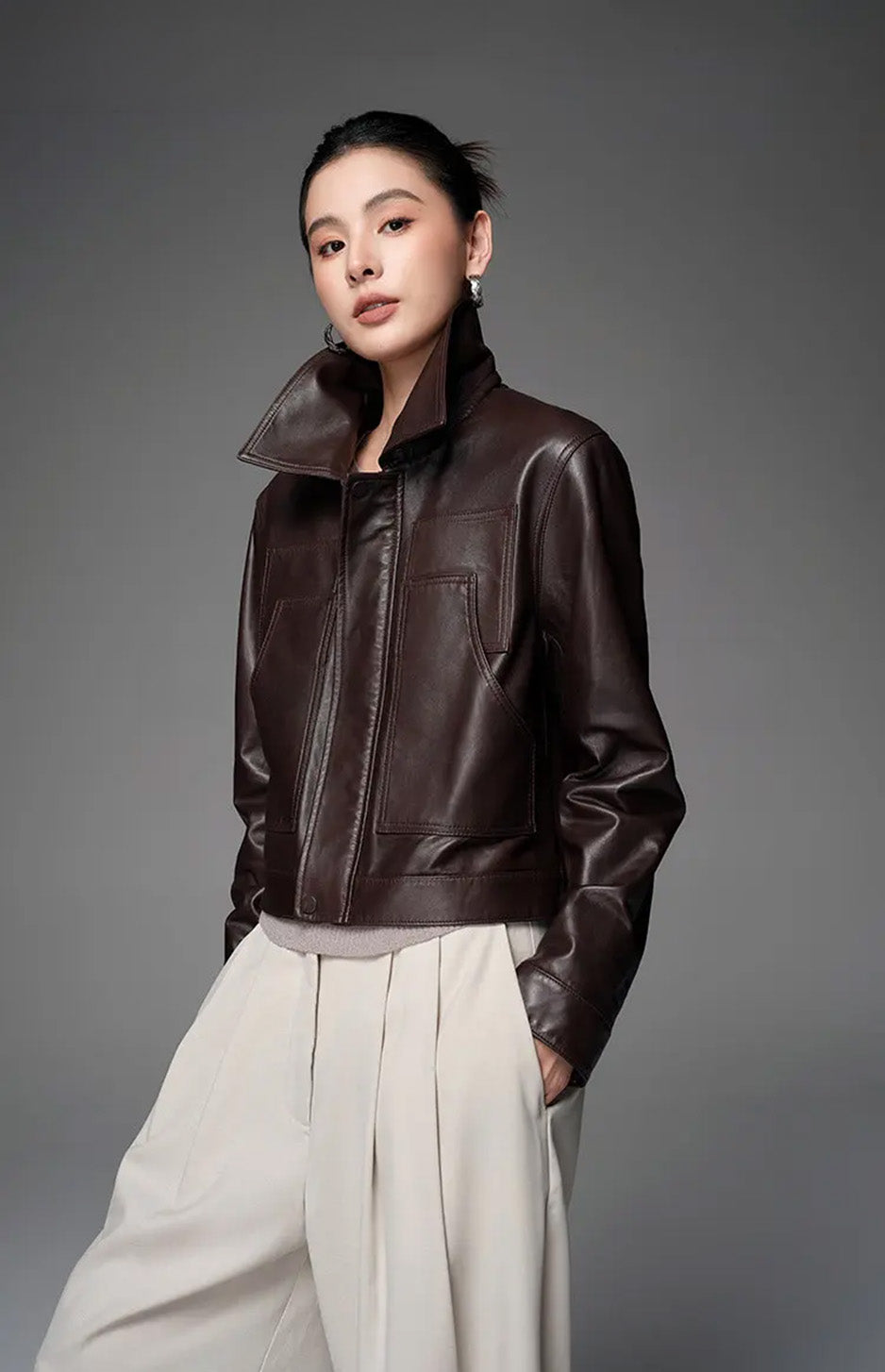 Model styling the Rich Juniper cropped leather jacket with the sharp-pointed collar raised — From Borcelleclothes.