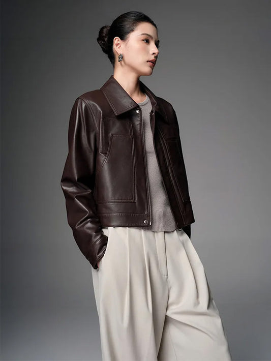 Model wearing the cropped fine-grain sheepskin jacket in Rich Juniper, turned slightly to the side — From Borcelleclothes.
