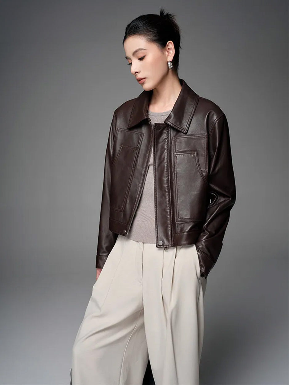 Three-quarter view of the model wearing the unzipped Rich Juniper leather jacket, looking down — From Borcelleclothes.