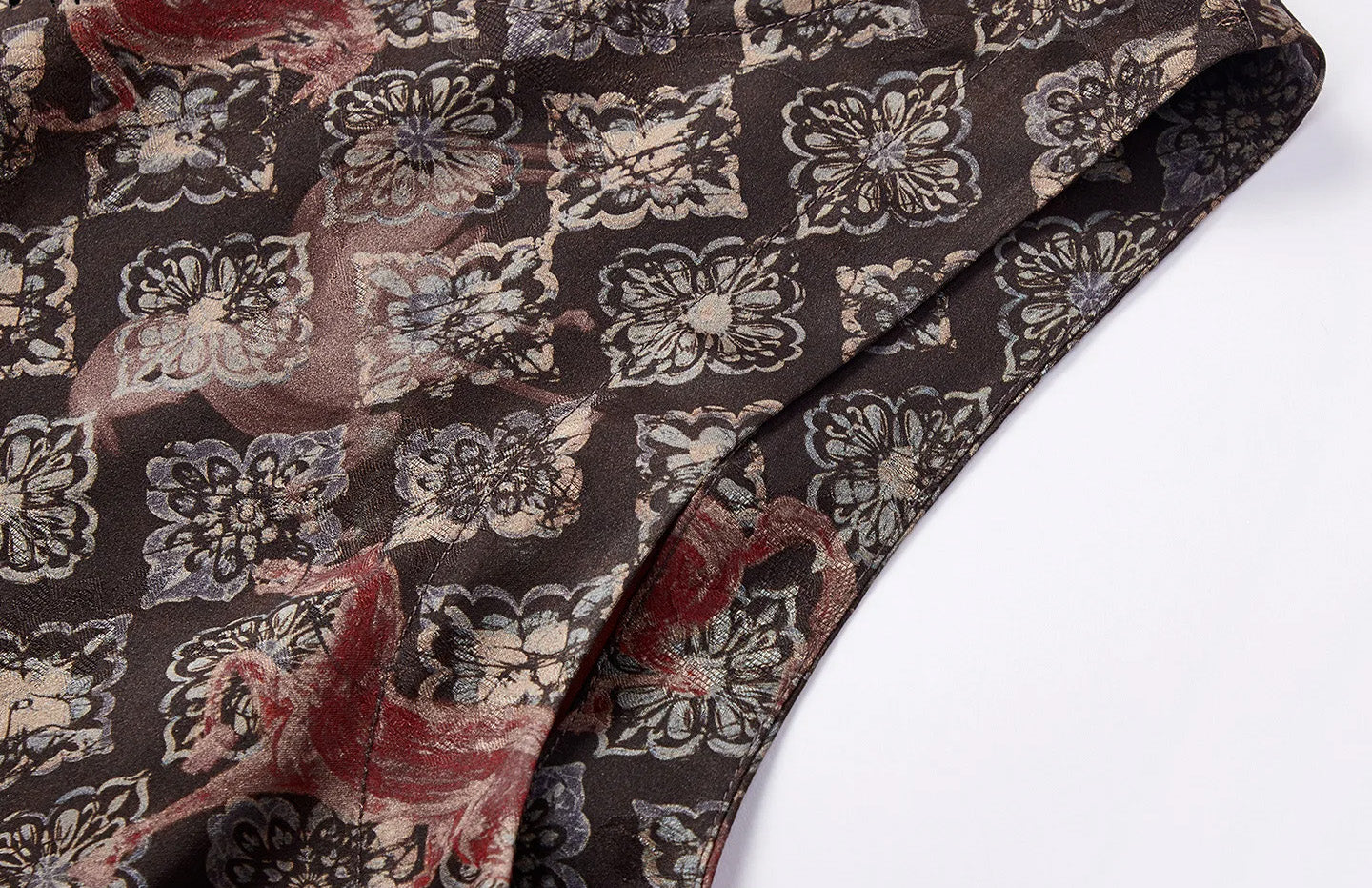 Detailed view of the clean, tailored armhole finish and structured silk drape — From Borcelleclothes.
