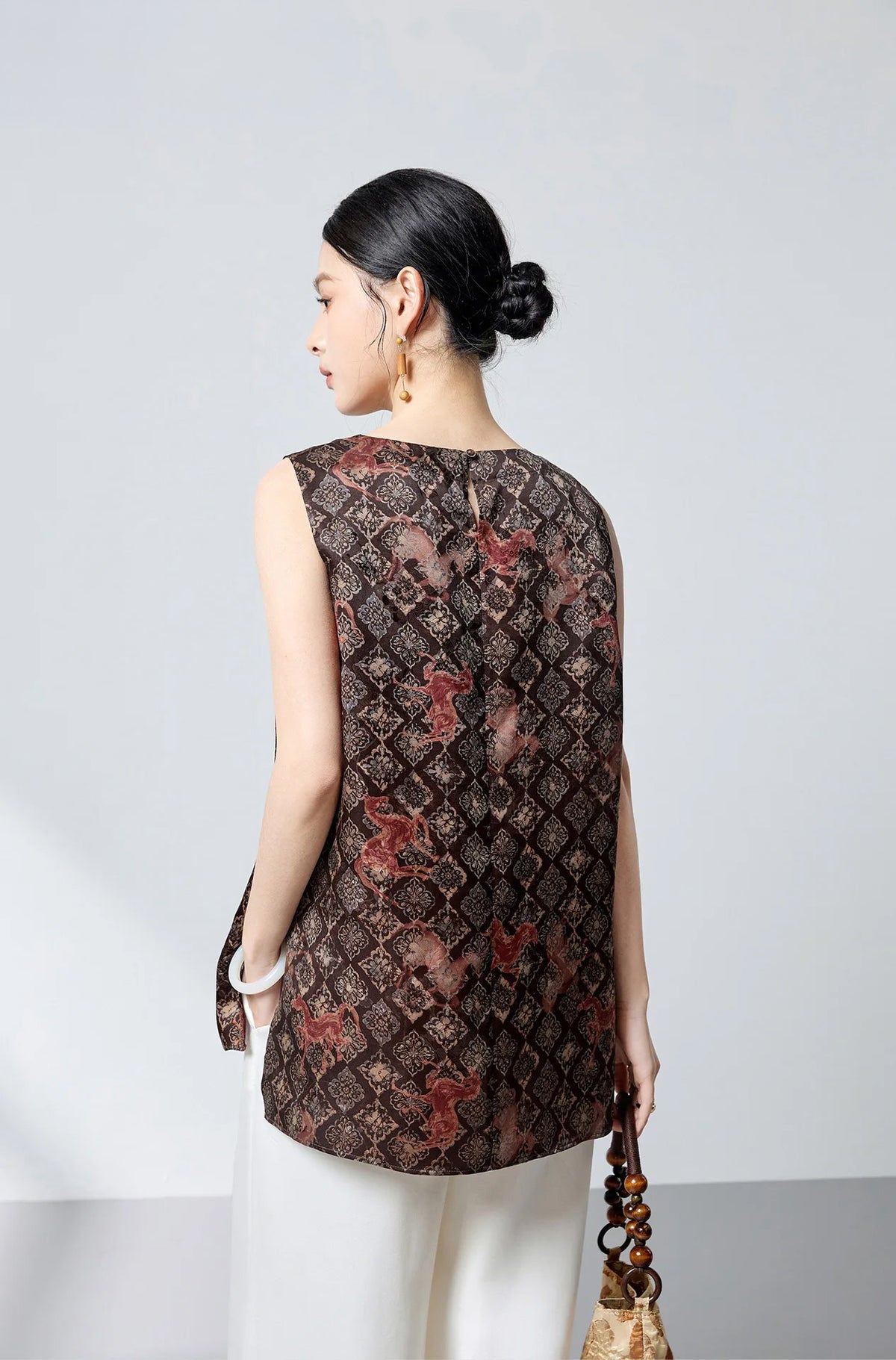 Back view of the sleeveless Xiangyunsha silk top showing the refined drape and clean silhouette — From Borcelleclothes.