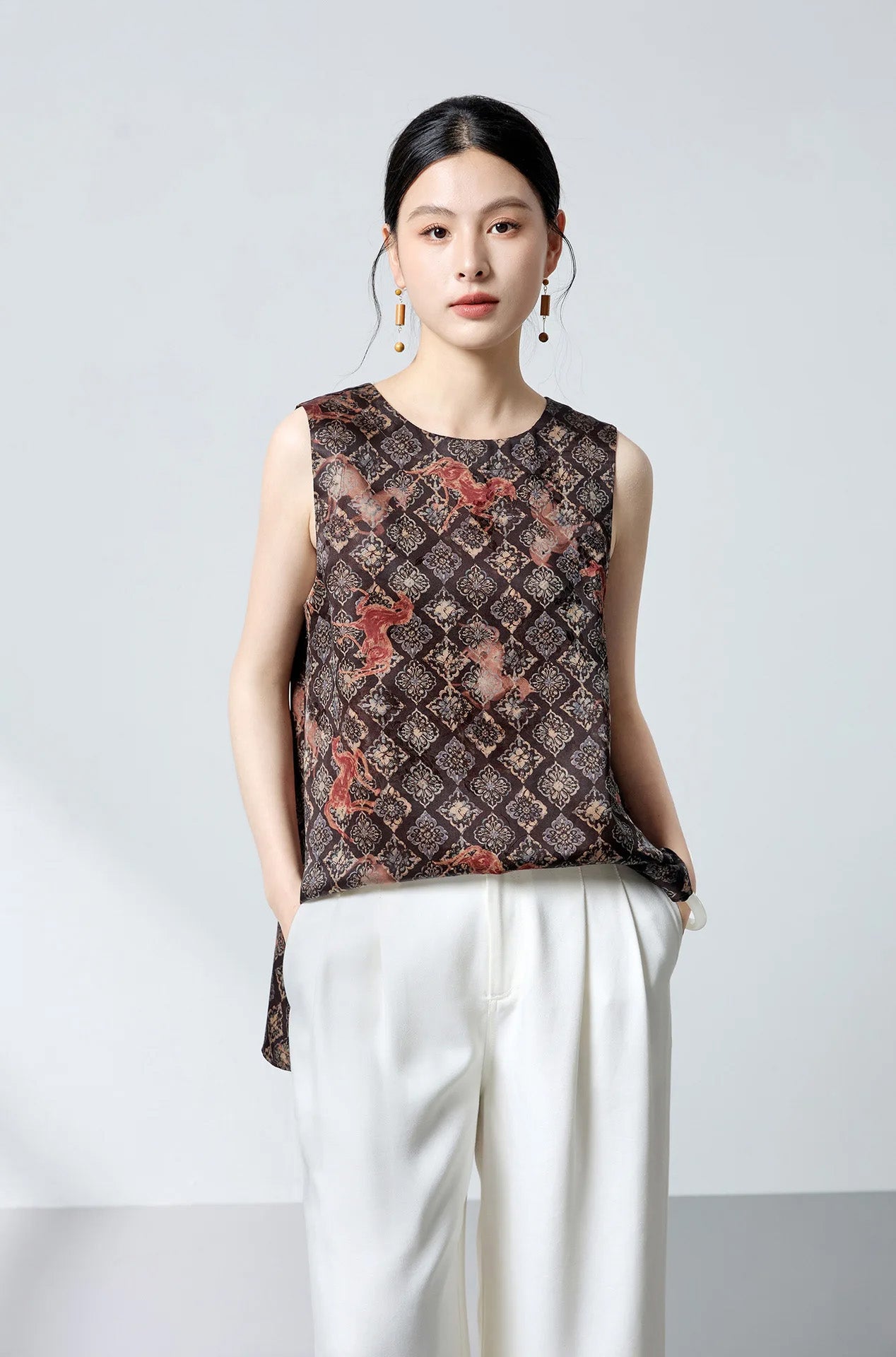 Model posing with hands in tailored trouser pockets wearing the relaxed-fit Mulberry silk jacquard top — From Borcelleclothes.