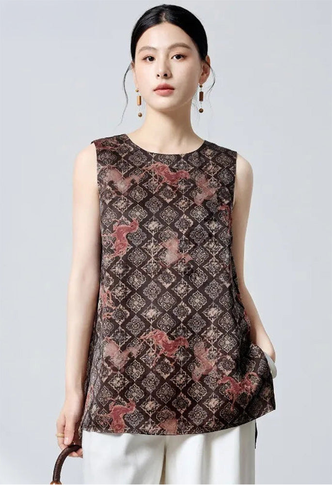 Editorial shot of the model holding a bag with one hand resting in her pocket wearing the silk jacquard top — From Borcelleclothes.