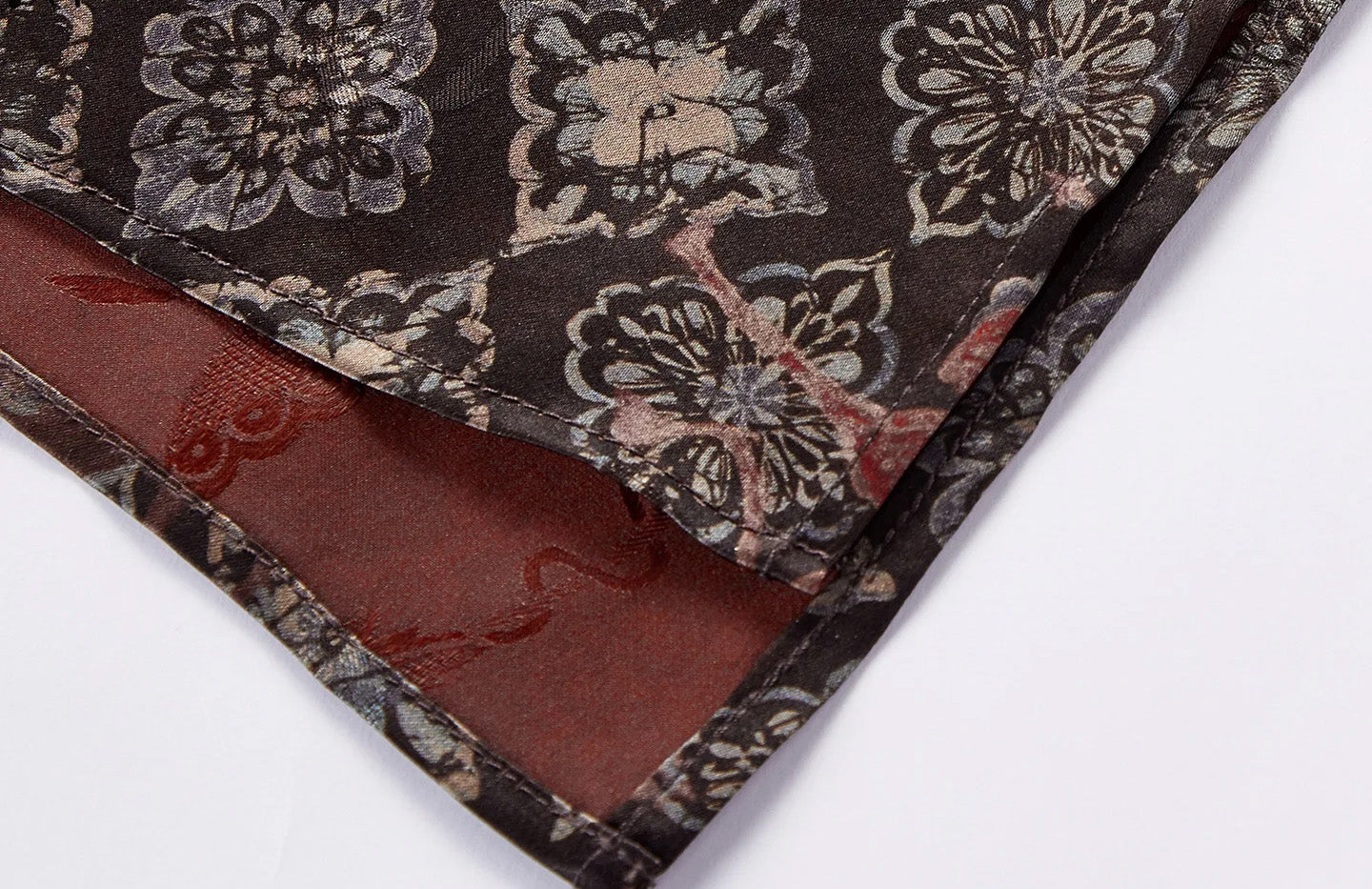 Close-up of the side slit hem revealing the glowing terracotta amber underside — From Borcelleclothes.
