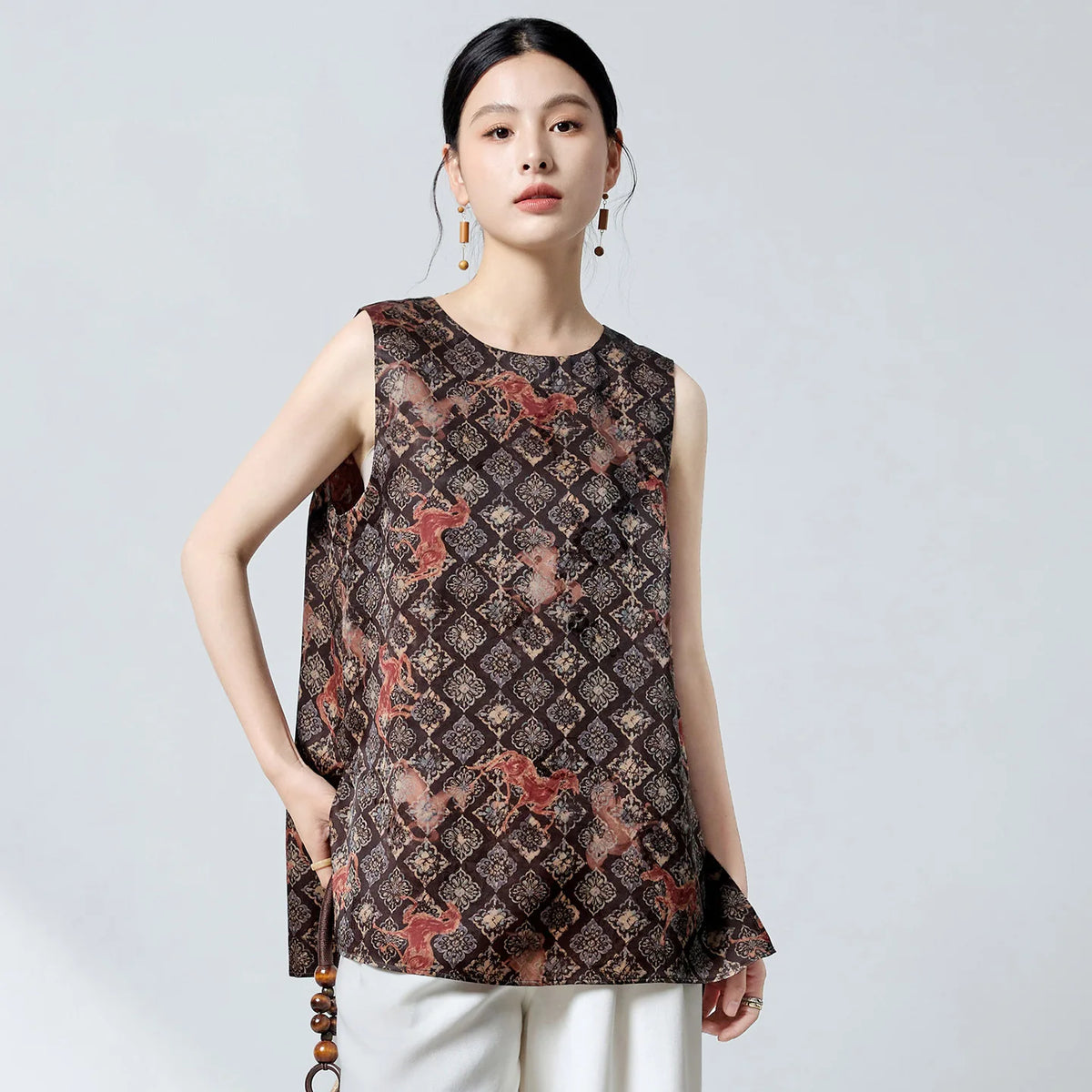 Women's 100% Mulberry Xiangyunsha silk top in Fire Steeds. Features selective jacquard reliefs, an espresso-and-terracotta finish, and floral rosettes overlaid with fire steeds. — From Borcelleclothes.