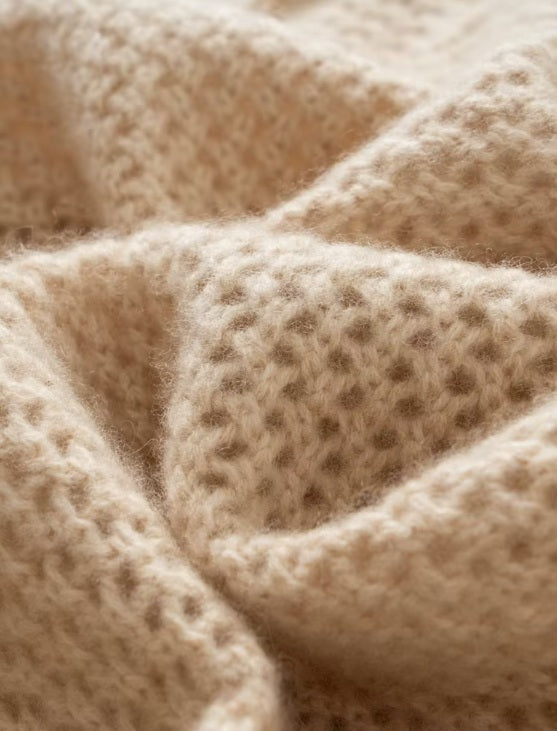 Wave-folded texture highlighting the airy mesh and floral pattern of the Brandy sweater — From Borcelleclothes.