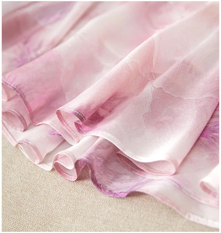 Detailed view of the immaculate stitching on the wave-curved bottom flounces of the midi silk dress — From Borcelleclothes.