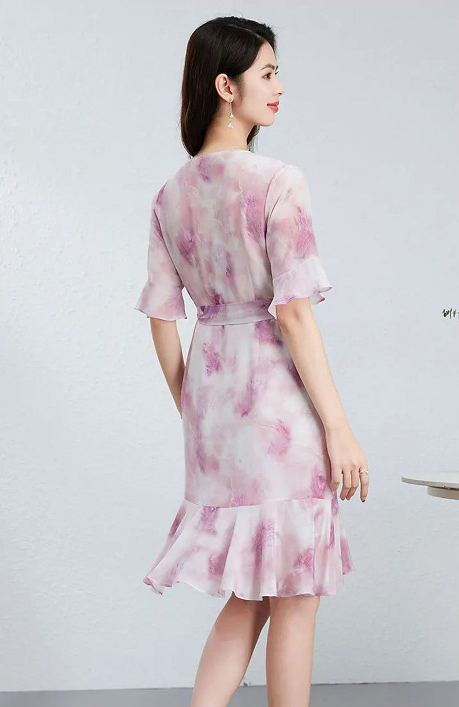 Back view of a woman in a crepe de chine silk dress, capturing the graceful movement and structured lines of the design — From Borcelleclothes.