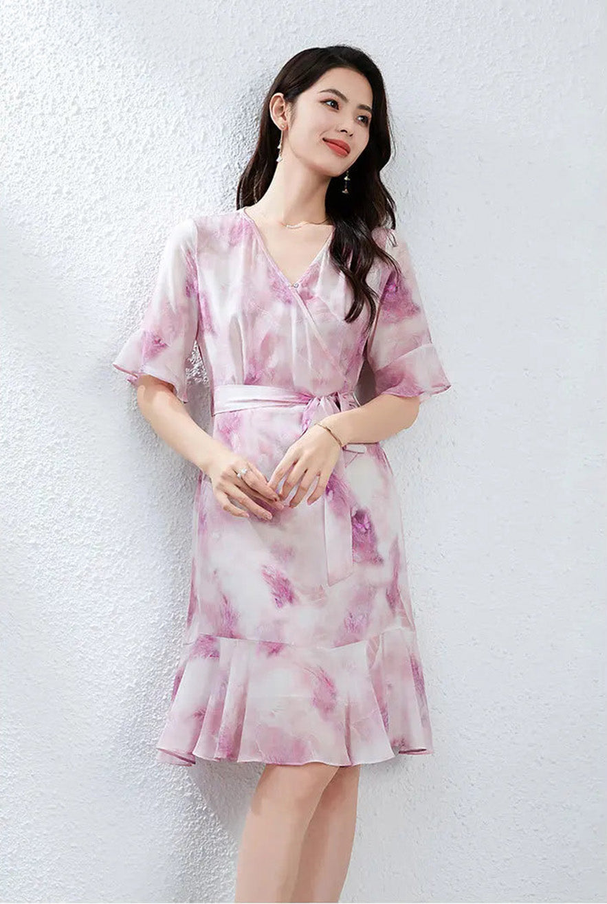 A woman in a Highland Heather silk dress gently touching her fingertips together, reflecting a sense of inner peace and freedom — From Borcelleclothes.