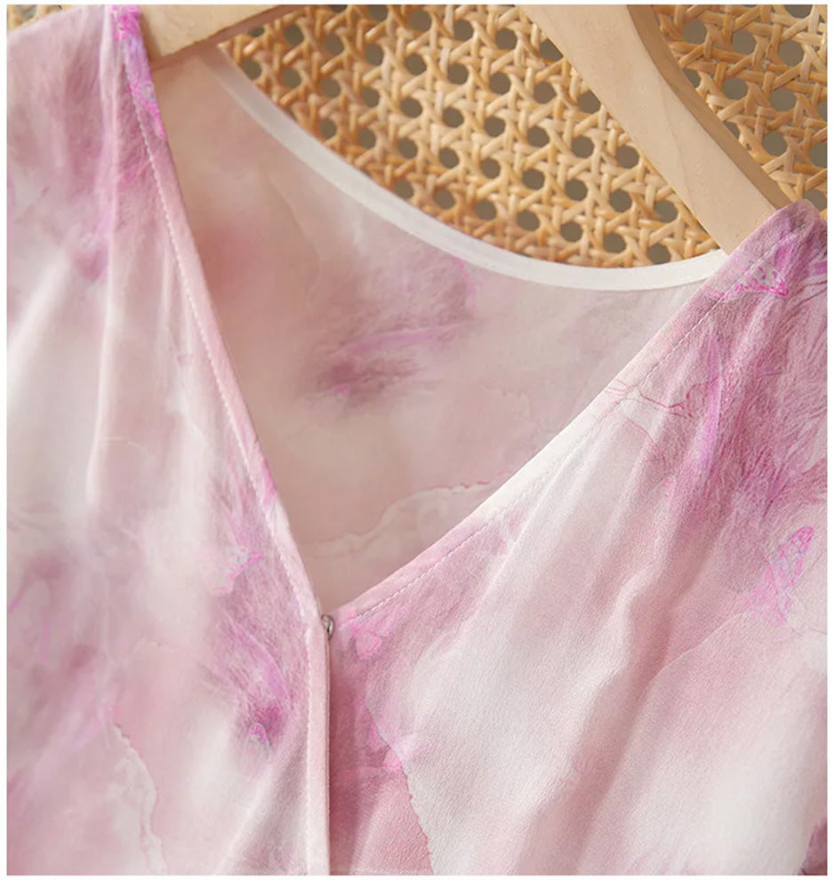 Close-up of the clean architectural lines of the V-neckline on the Highland Heather silk dress — From Borcelleclothes.
