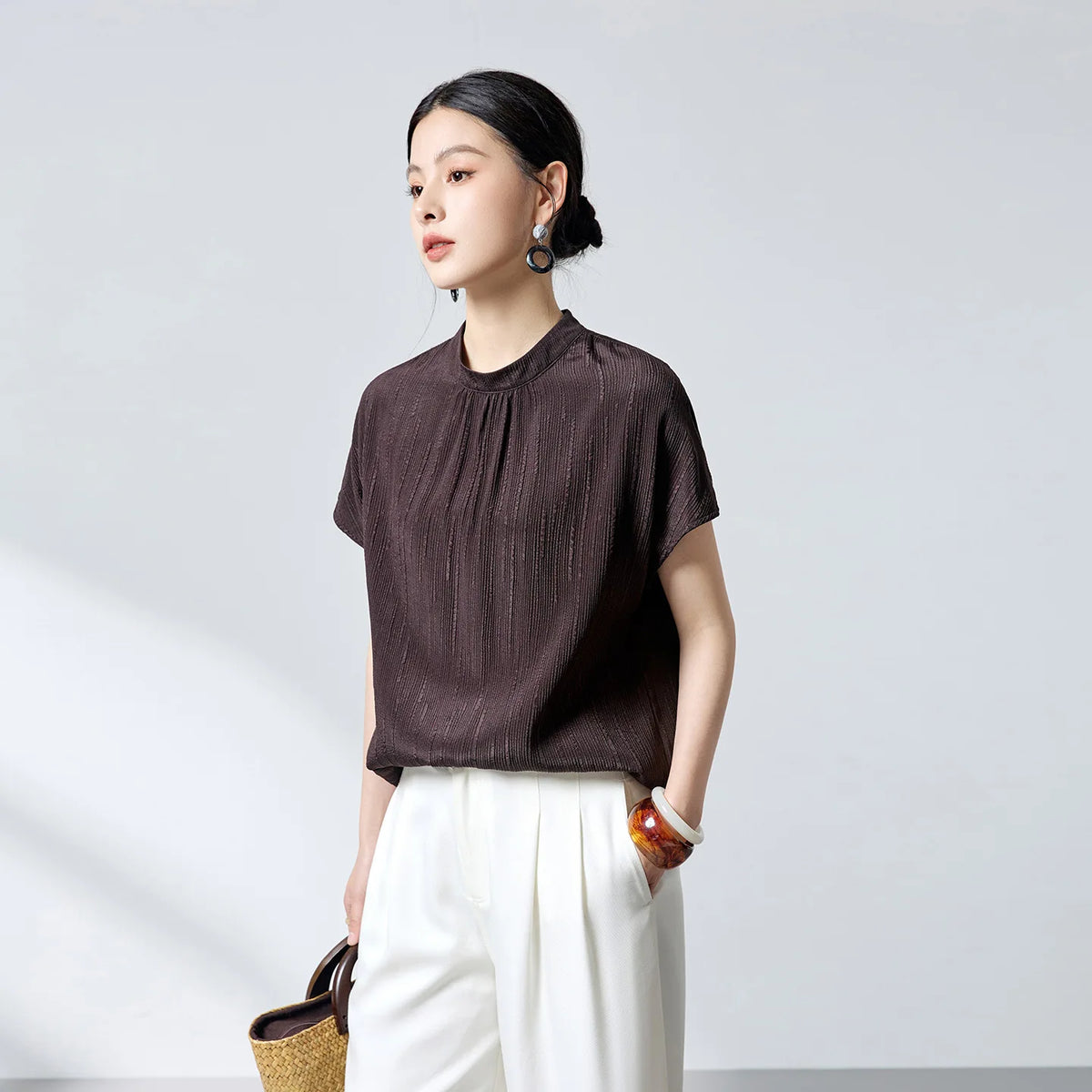Women's 19 Momme stretch silk jacquard blouse in Carried by Monsoon. Features fluted texture, delicate gathers beneath a stand collar, and short kimono sleeves. — From Borcelleclothes.