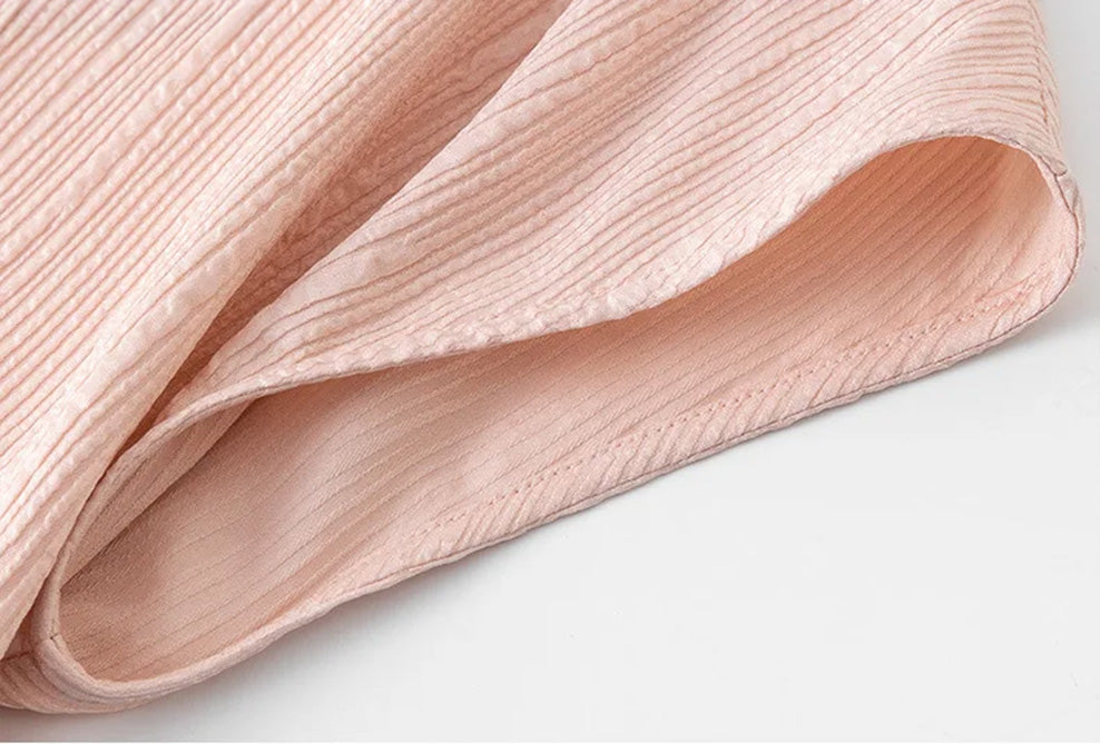 Armhole construction and stitching detail on women's pink silk blouse by Borcelleclothes.
