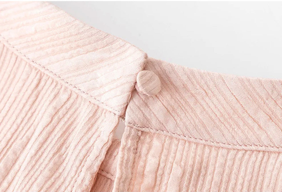 Back closure detail on stand collar of pink silk jacquard blouse by Borcelleclothes.