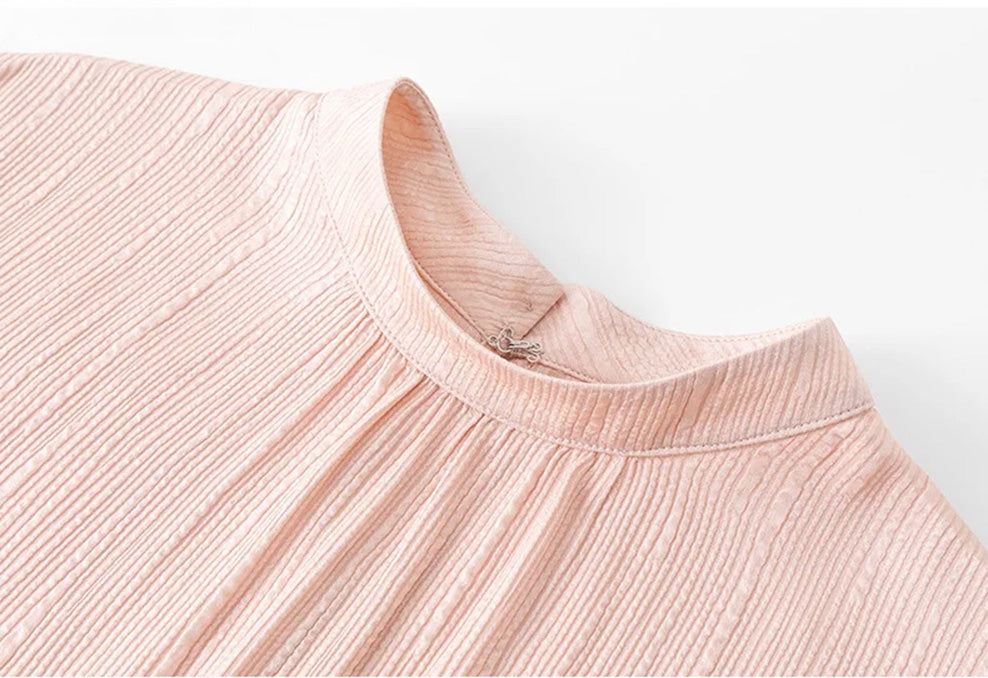 Front detail of stand collar on pink fluted jacquard silk blouse by Borcelleclothes.