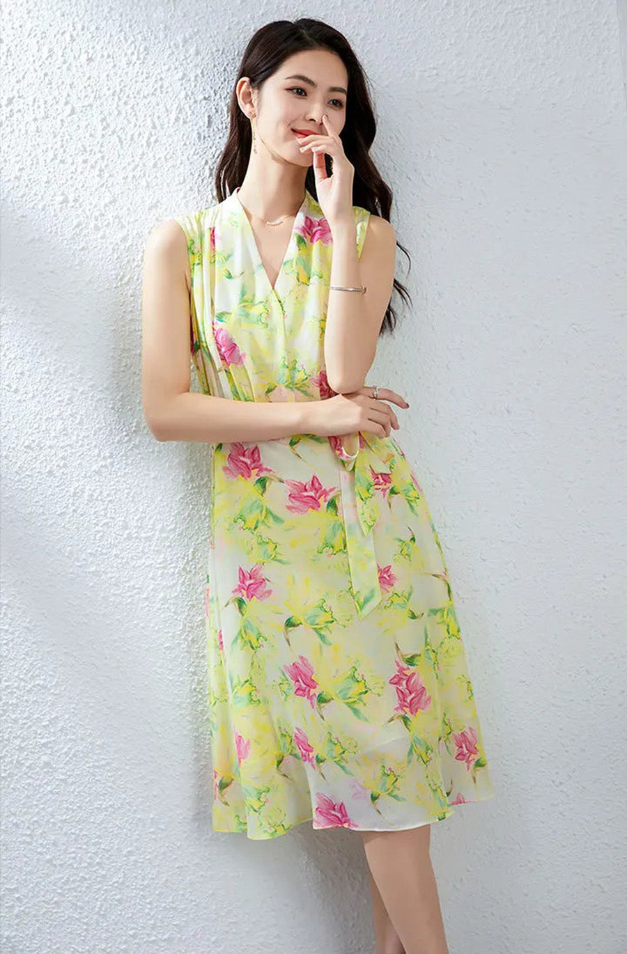 Woman touching her lips, wearing the Magnolia in May silk dress with its distinct framed collar in soft focus — From Borcelleclothes.