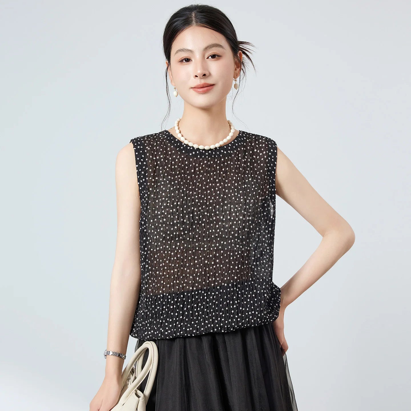 Women's Sleeveless 18-momme Mulberry silk blouse in 3D puckered jacquard. Front-to-back design with mother-of-pearl buttons in Dans Tes Bras. — From Borcelleclothes.