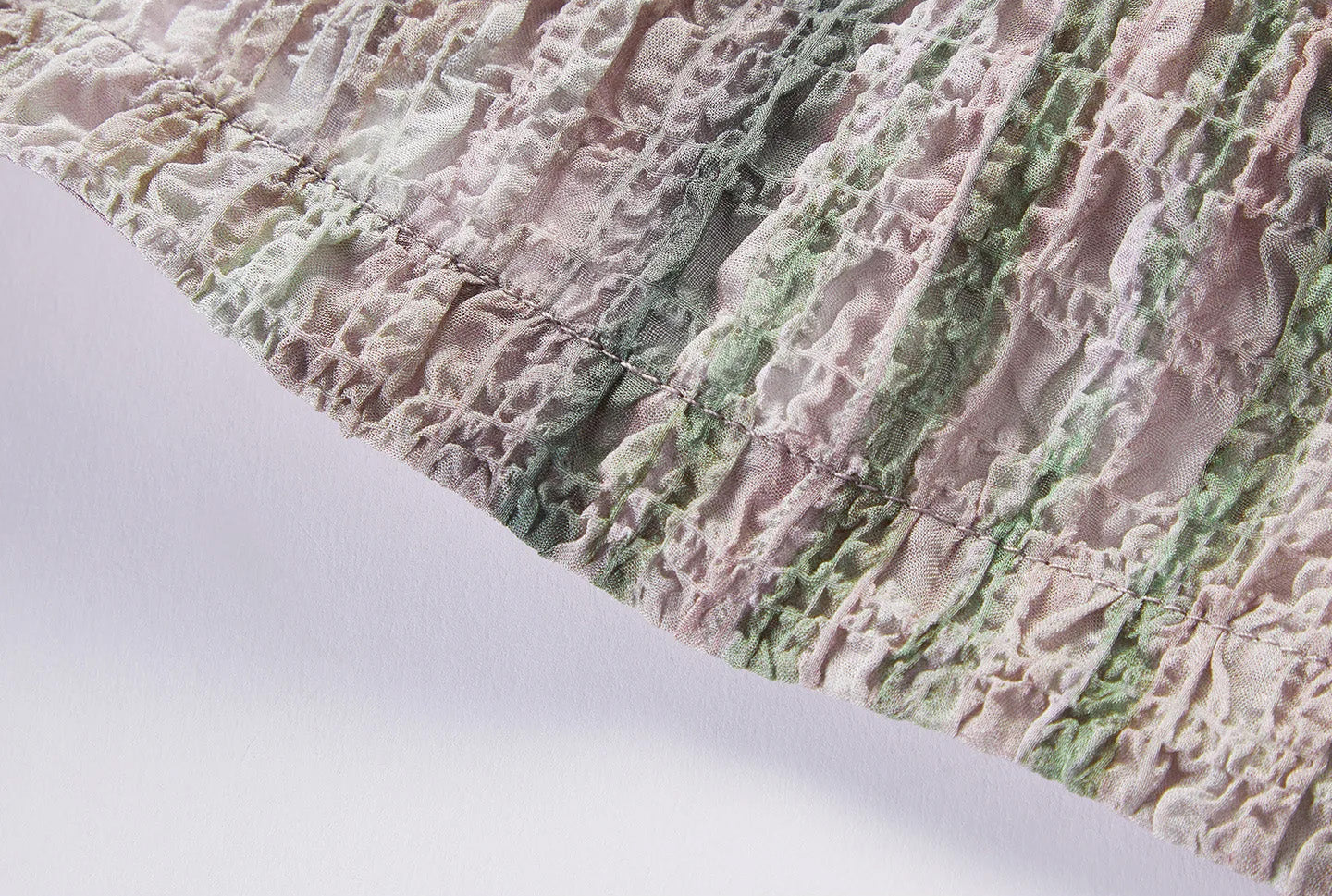 Close-up of bottom hemline showing 3D puckered silk jacquard texture and elastic drawstring — From Borcelleclothes.