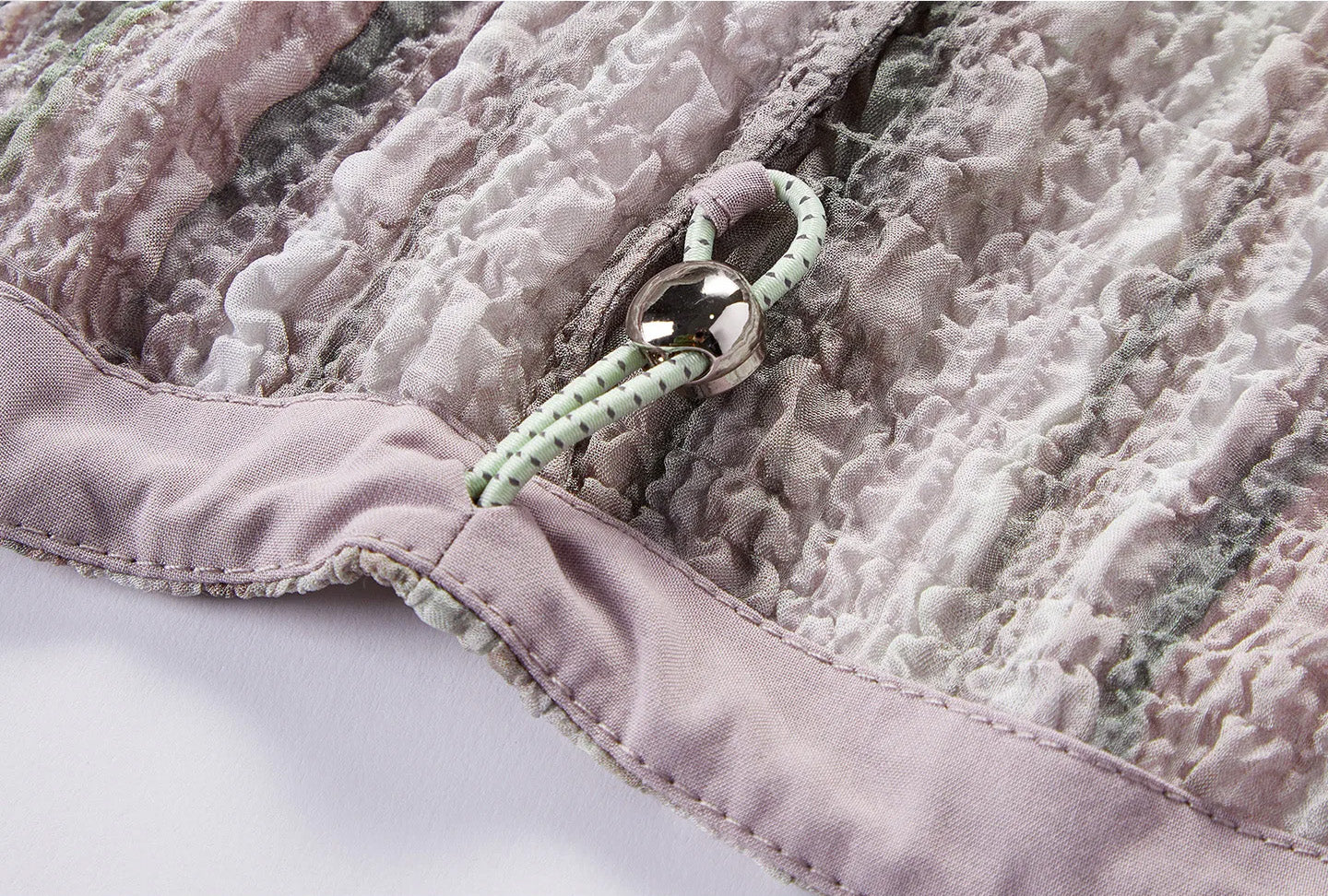 Interior detail of bottom hem casing with adjustable elastic drawstring and cord lock — From Borcelleclothes.