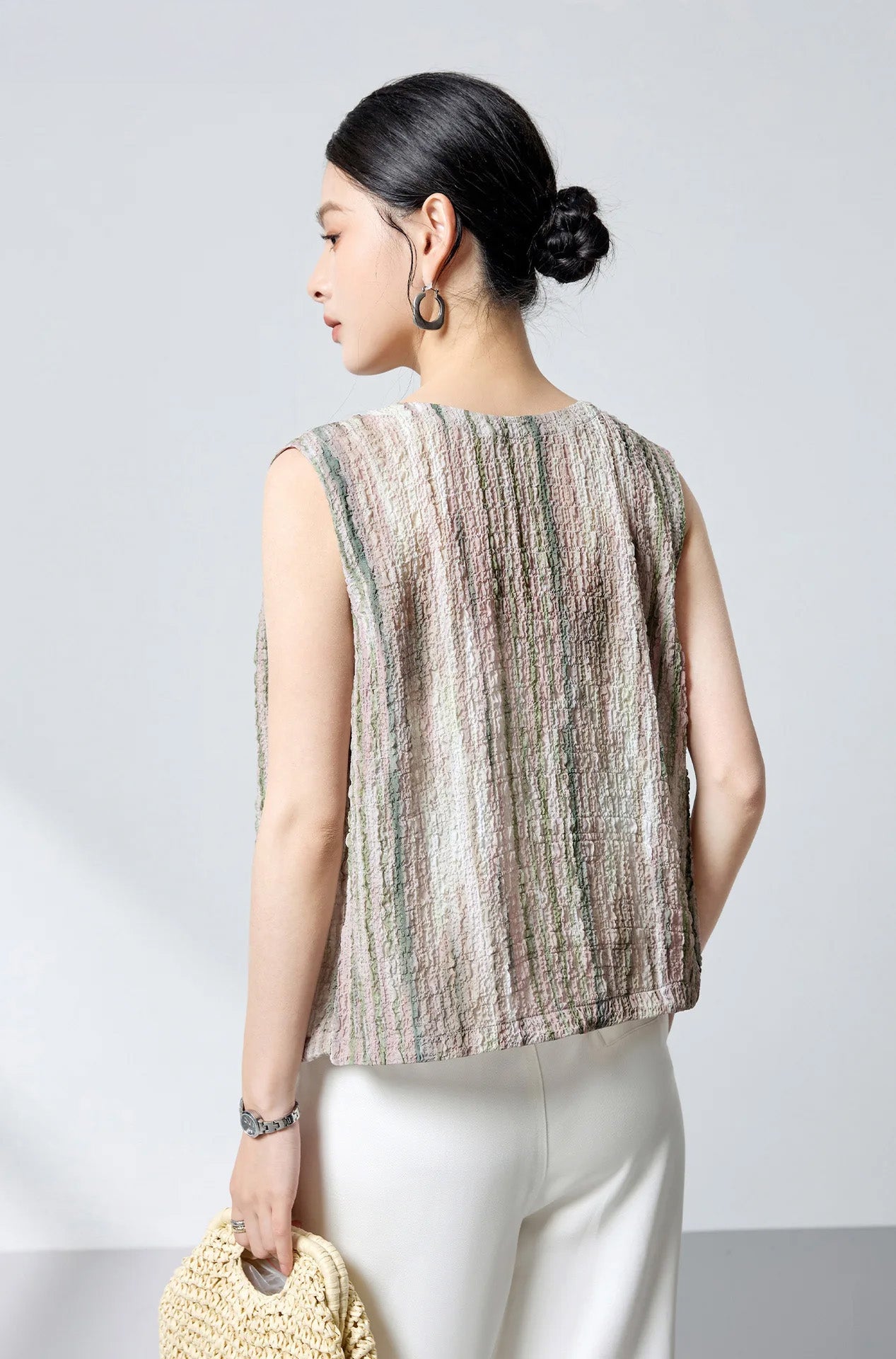 Back view of sleeveless silk blouse worn with mother-of-pearl buttons in the front — From Borcelleclothes.
