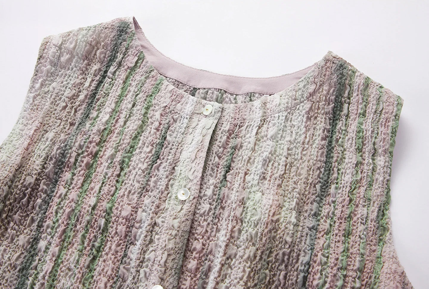 Close-up of neckline, round collar, and mother-of-pearl button placket on silk jacquard blouse — From Borcelleclothes.