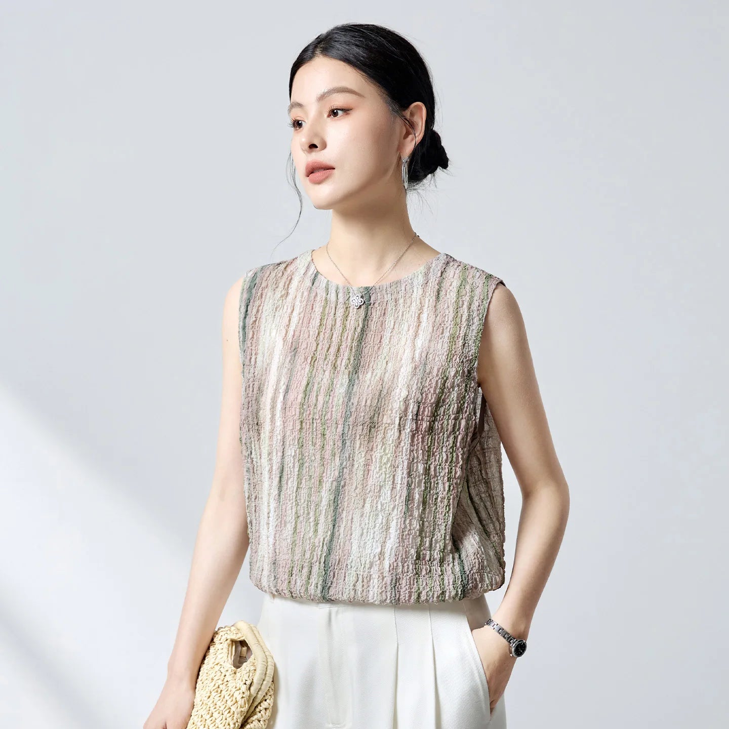 Women's Sleeveless 18-momme Mulberry silk blouse in 3D puckered jacquard. Front-to-back design with mother-of-pearl buttons in Promesse de l’Aube. — From Borcelleclothes.