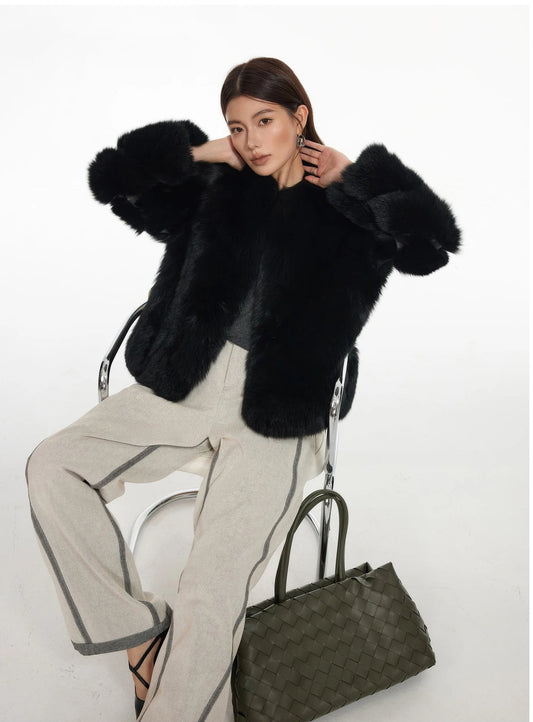 Seated model in Dark Witshade full-skin Finnish fox fur coat, hands resting gently at the neck — From Borcelleclothes.