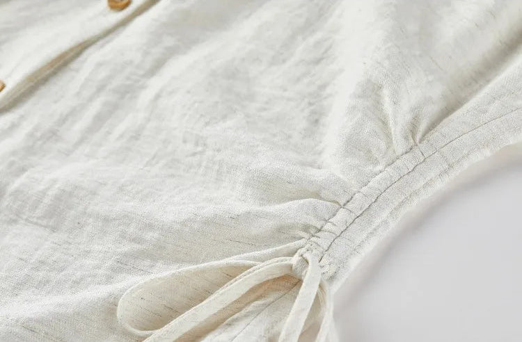 Detailed view of the side drawstring casings and functional ties that define the woman's waist. — From Borcelleclothes.