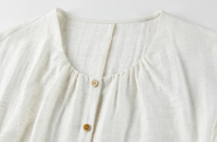 Close-up of the deep neckline with central gathering, highlighting the artisanal feel of the design. — From Borcelleclothes.