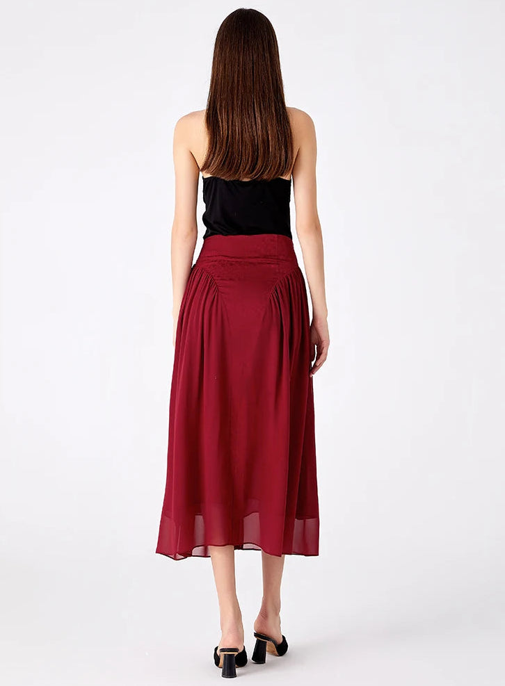 Full back view of a model wearing a high-waisted structured Mulberry silk midi skirt — From Borcelleclothes.