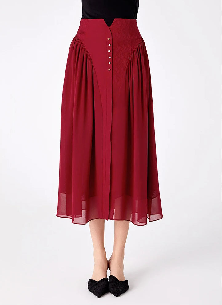 Front view of a model wearing a high-waisted Mulberry silk midi skirt with a decorative buttoned placket — From Borcelleclothes.