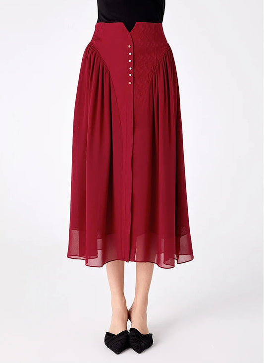 Front view of a model wearing a high-waisted Mulberry silk midi skirt with a decorative buttoned placket — From Borcelleclothes.