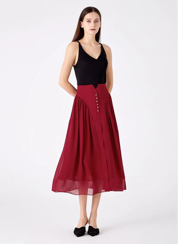 Model with hands behind her back wearing a structured silk midi skirt — From Borcelleclothes.